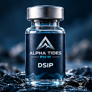 DSIP vial with silver cap and navy Alpha Tides PNW label on a rocky coast
