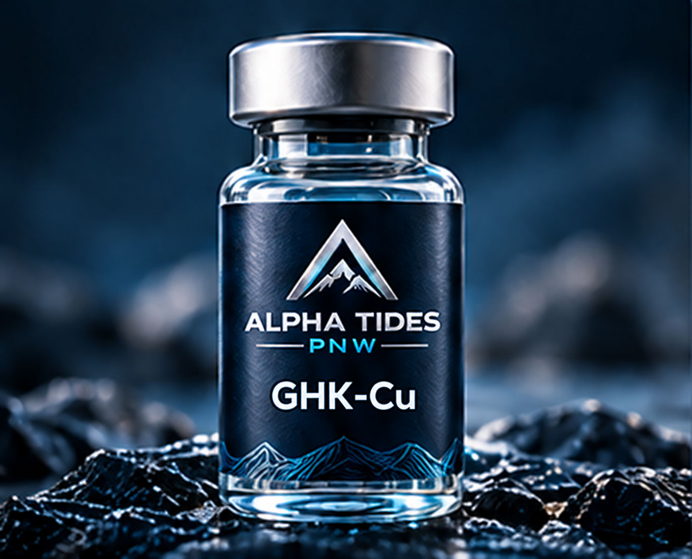 GHK-Cu vial with silver cap and navy Alpha Tides PNW label on a rocky coast