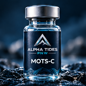 MOTS-C vial with silver cap and navy Alpha Tides PNW label on a rocky coast